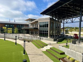 a large building with a lawn in front of it